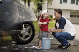 man and son washing car
